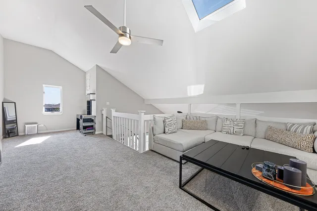 a living room with furniture and a ceiling fan