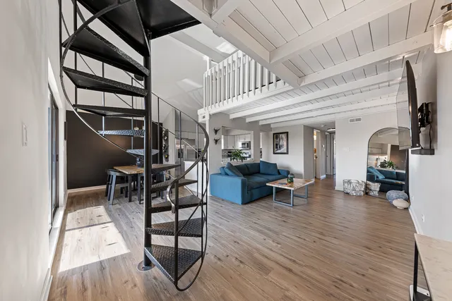 a view of a livingroom with furniture and a window