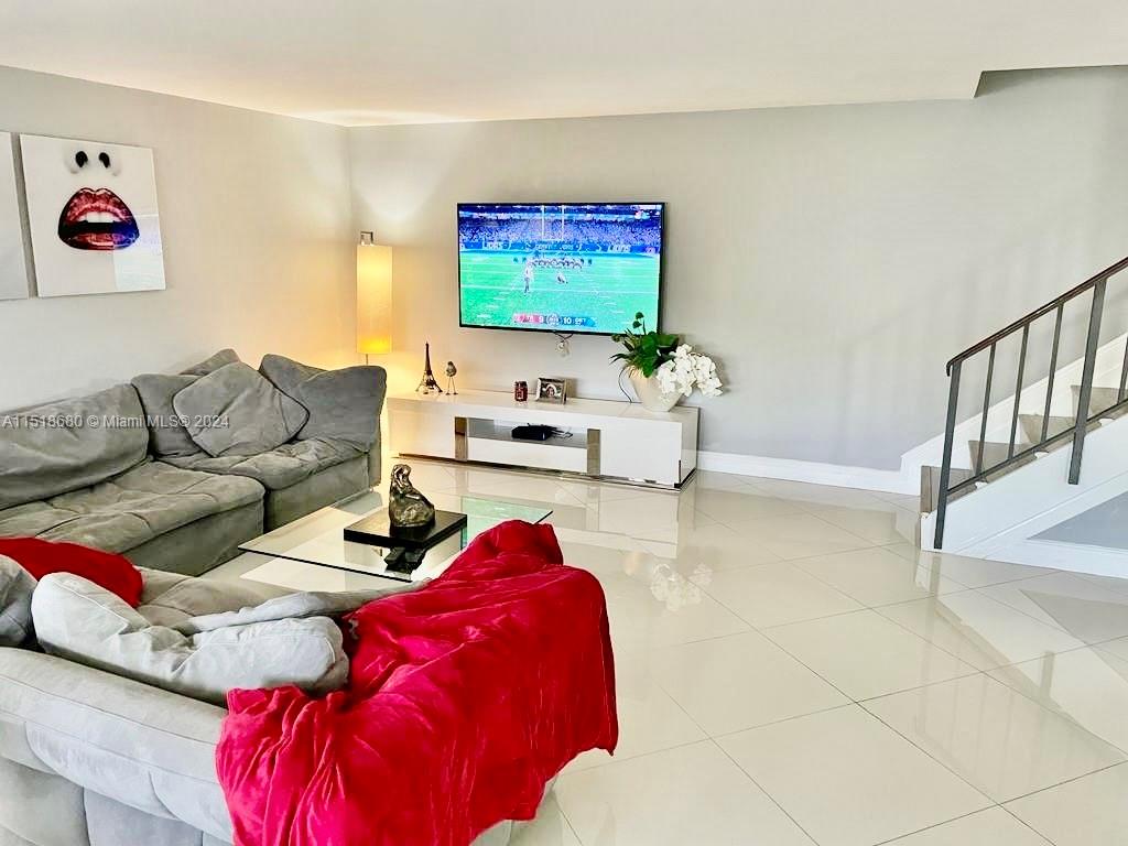 9410 Southwest 61st Way, Unit B Boca Raton, FL 33428 - Photo 3 of 32 a living room with furniture and a flat screen tv