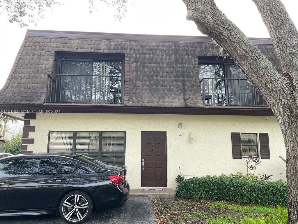 9410 Southwest 61st Way, Unit B Boca Raton, FL 33428 - Photo 8 of 32 a front view of a house with parking space