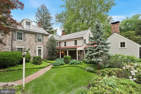 a view of backyard of house with green space