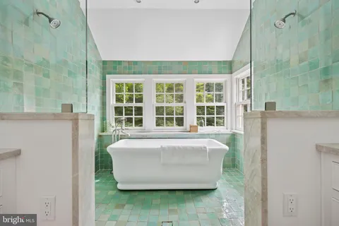 a spacious bathroom with a bathtub and shower