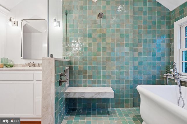 a bathroom with a sink a toilet a mirror and shower