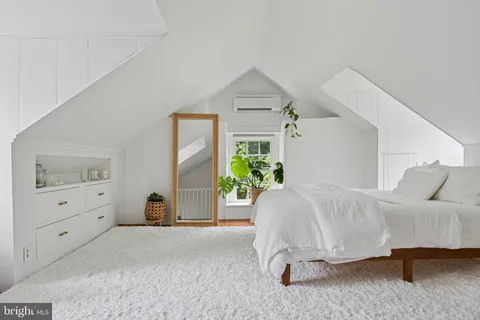 a spacious bedroom with a bed and a couch