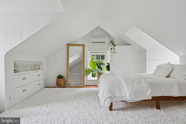 a spacious bedroom with a bed and a couch