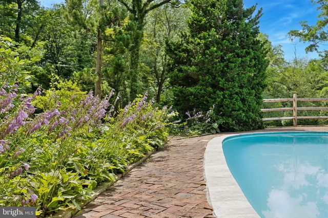 a view of a swimming pool with wooden fence