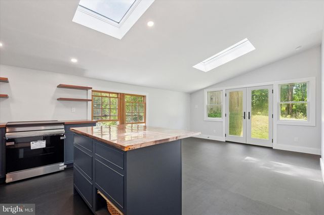 a kitchen with granite countertop a stove and a sink