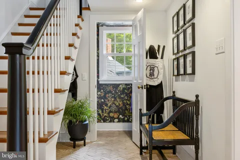a view of entryway and hall with wooden floor