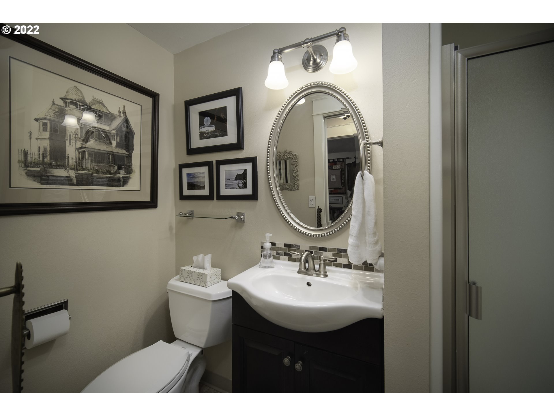 104 East Bay Point Road Gleneden Beach, OR 97388 - Photo 20 of 31 a bathroom with a toilet sink and mirror