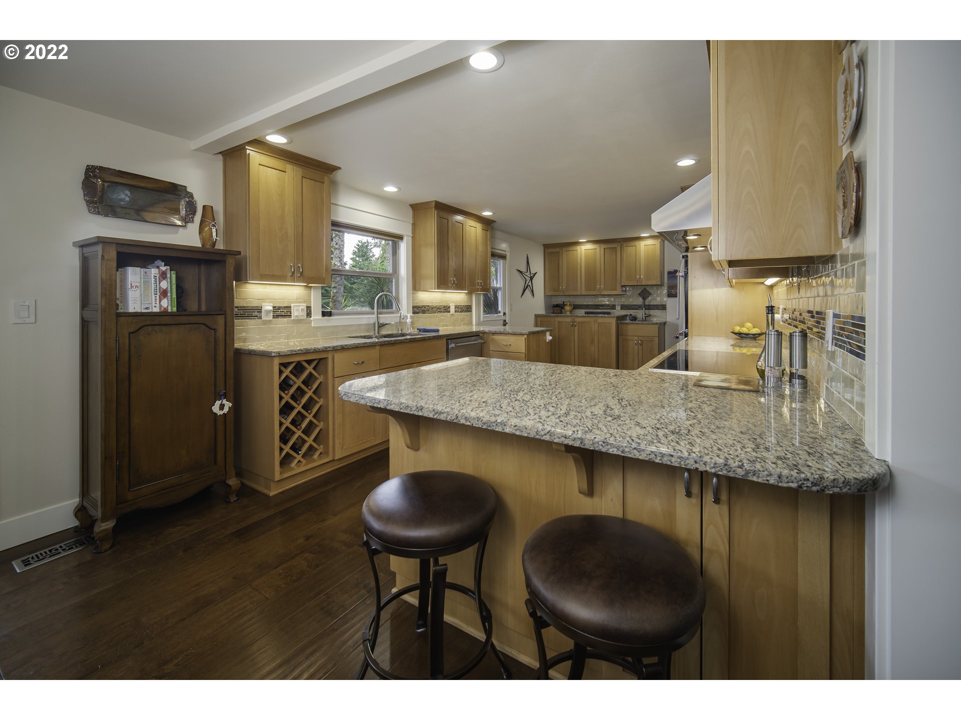 104 East Bay Point Road Gleneden Beach, OR 97388 - Photo 3 of 31 a kitchen with granite countertop kitchen island stainless steel appliances a sink and a refrigerator