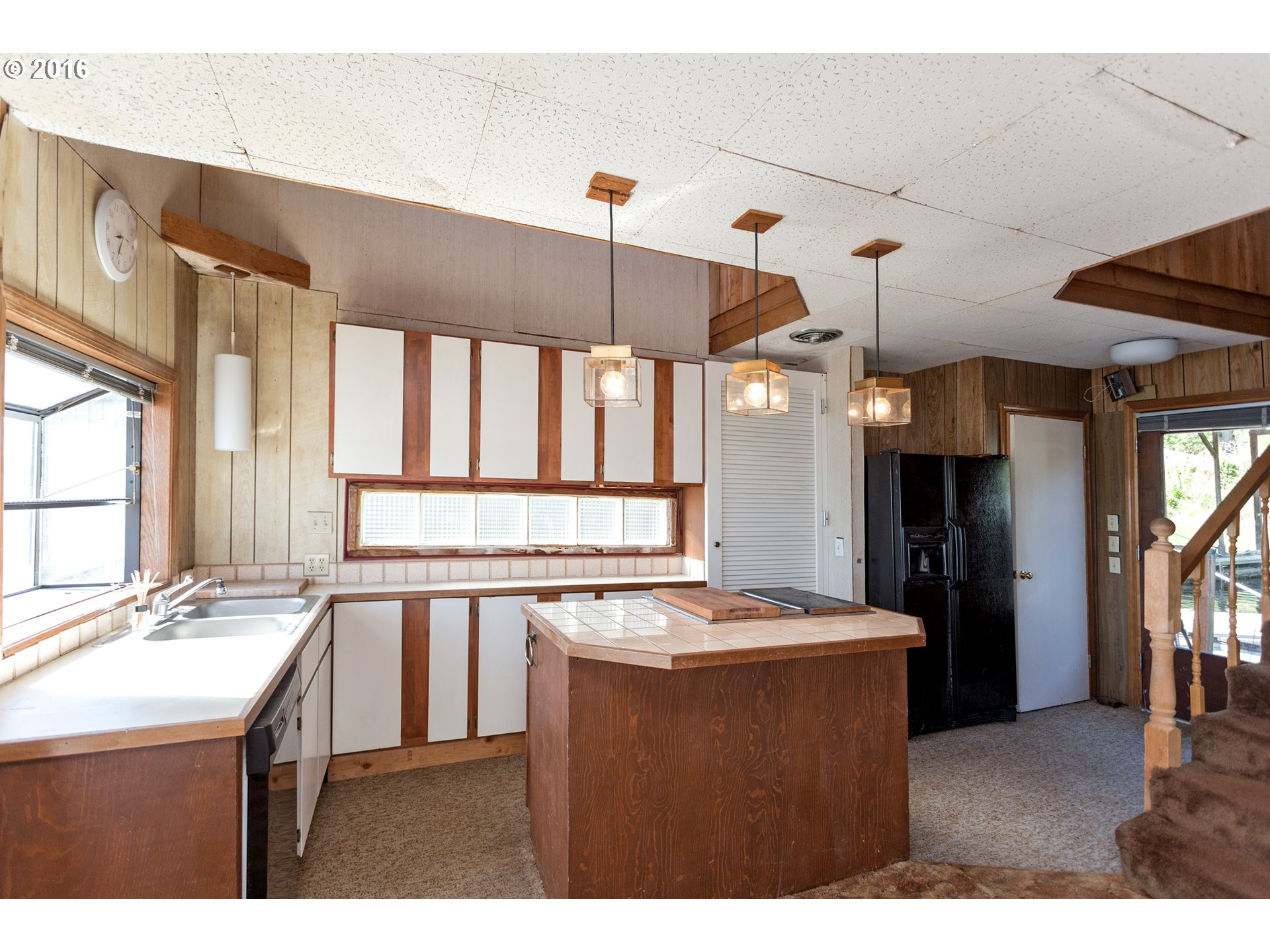 23586 Northwest St Helens Road, Unit L28 Portland, OR 97231 - Photo 8 of 28 a kitchen with a sink a window and stainless steel appliances