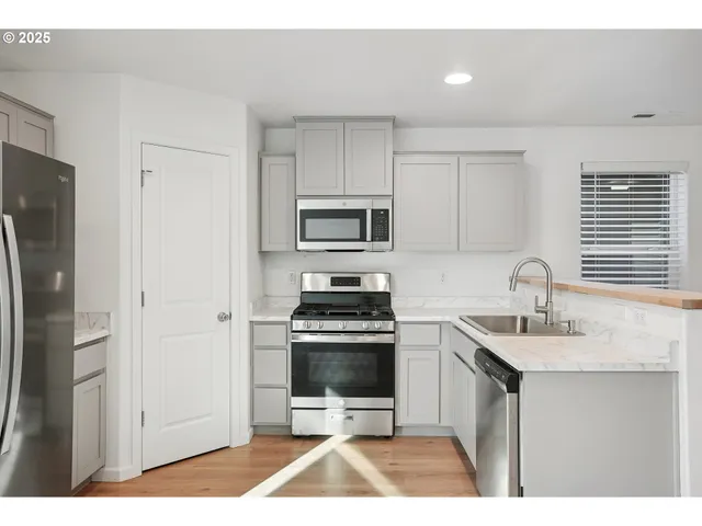 a kitchen with a sink stove and refrigerator