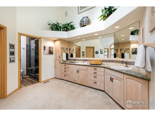 a large white kitchen with a large window