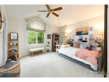 a bedroom with a bed couch and a window