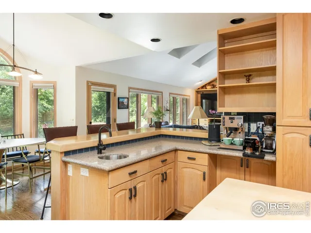 a kitchen with stainless steel appliances granite countertop a sink stove and cabinets