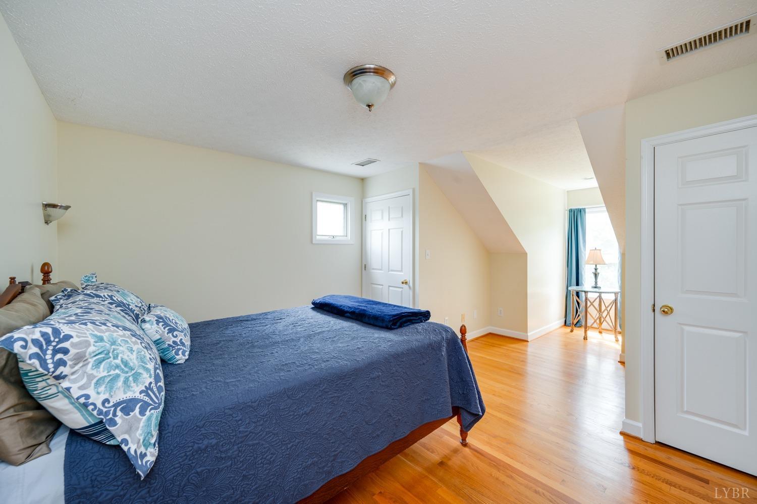 6412 Charlemont Road Goode, VA 24556 - Photo 54 of 99 a bedroom with a bed and wooden floor