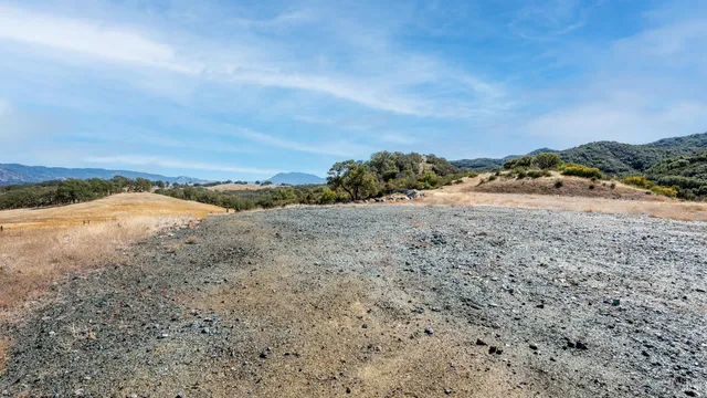 a view of a road with mountains in the background