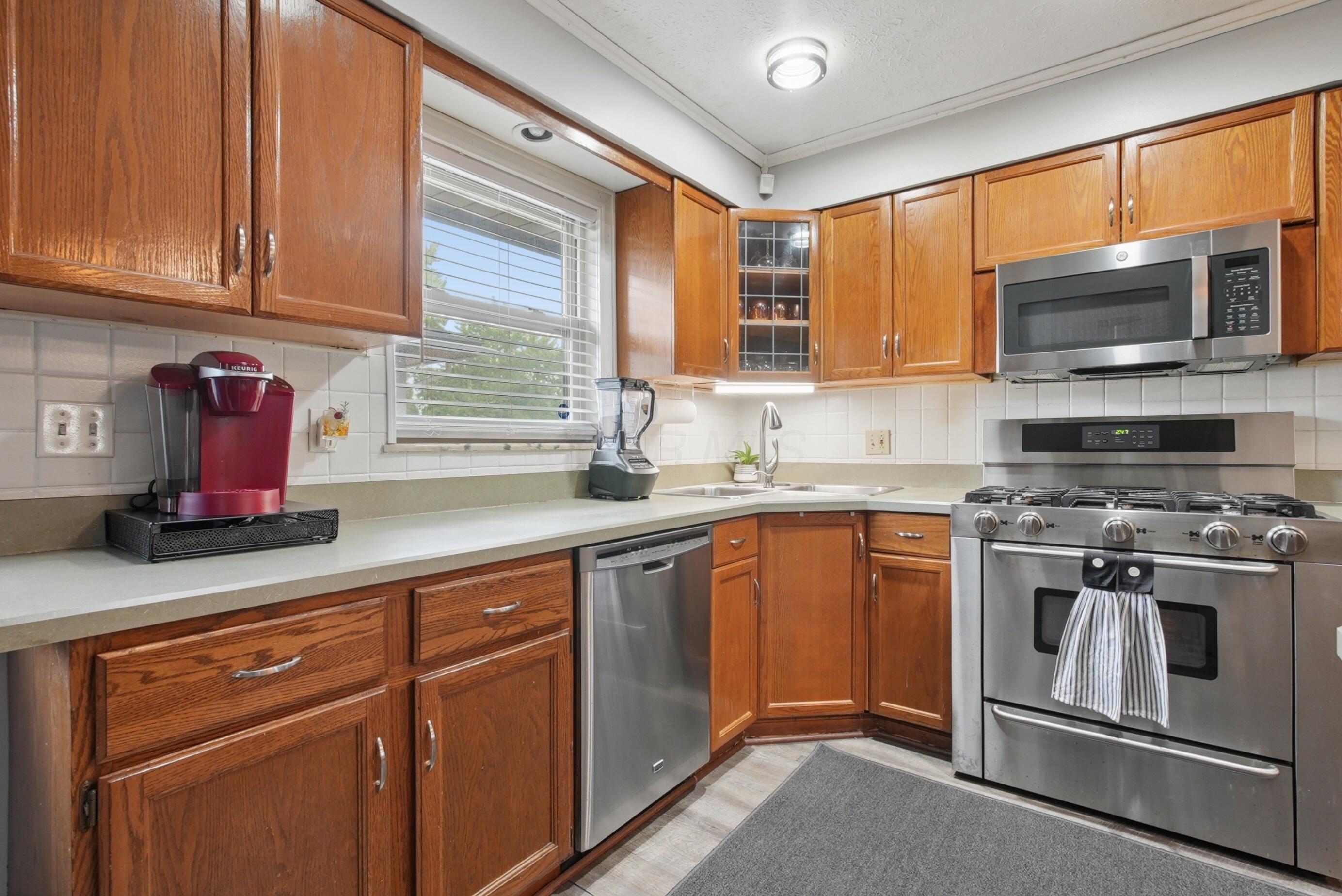1636 Courtright Road Columbus, OH 43227 - Photo 8 of 35 Stainless steel appliances, including an oven range, microwave, dishwasher (and refrigerator previously shown)