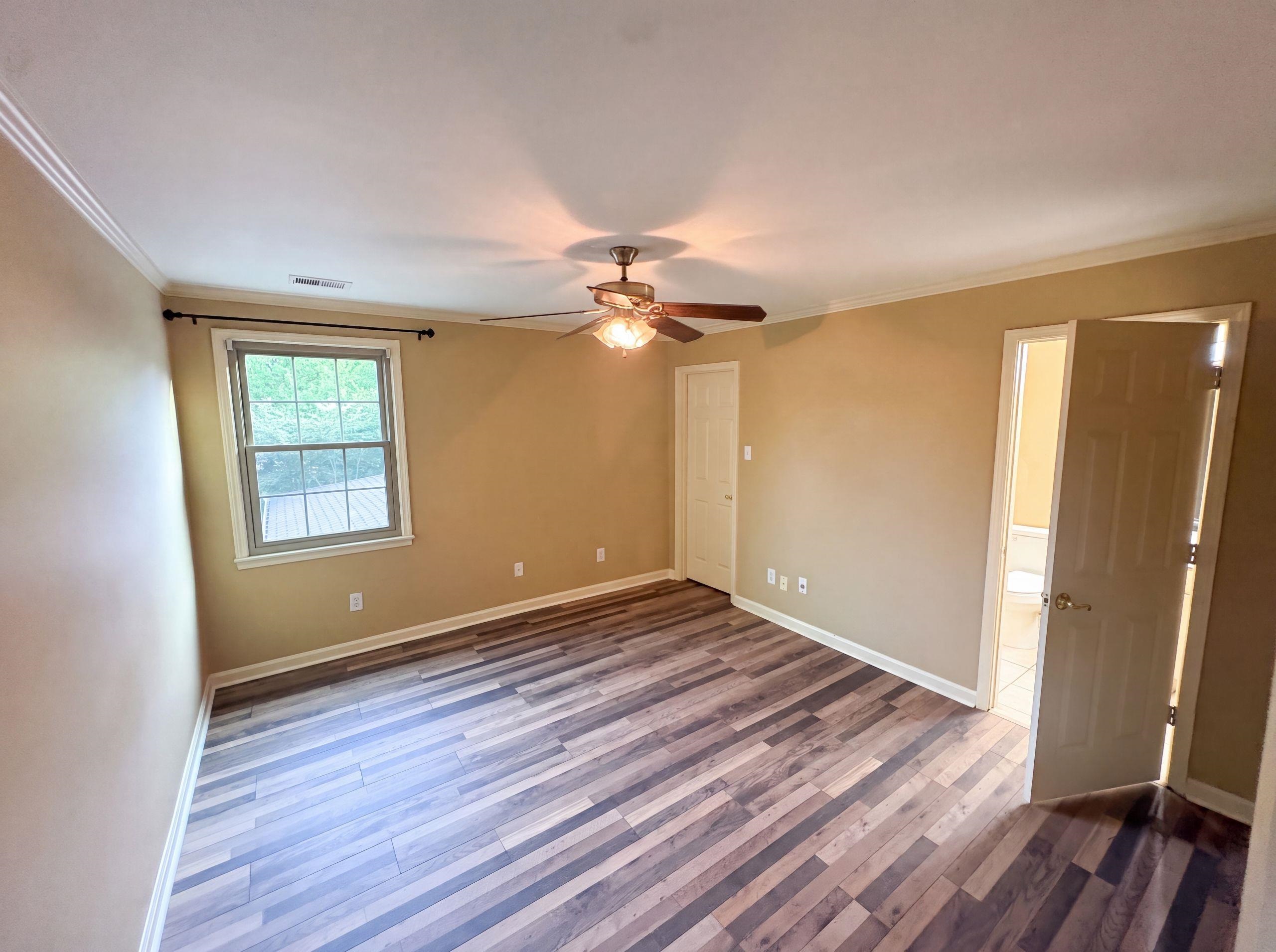 9424 Gotten Road Germantown, TN 38139 - Photo 14 of 27 Spacious room featuring wood-finish flooring, crown molding, a ceiling fan with integrated lighting, and a window with exterior visibility