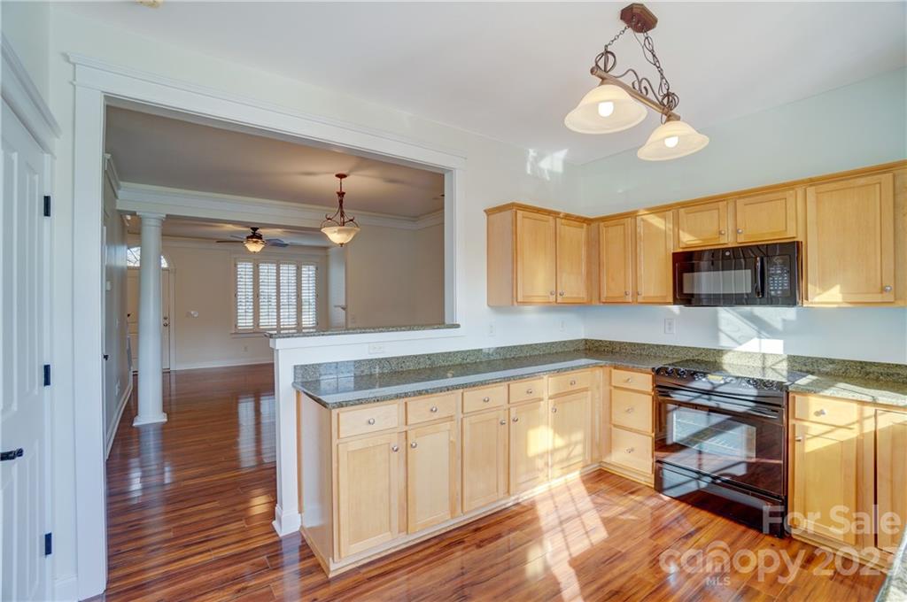 292 Elis Way Fort Mill, SC 29708 - Photo 11 of 22 a kitchen with stainless steel appliances granite countertop a refrigerator a sink dishwasher a stove and white cabinets with wooden floor