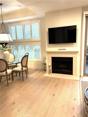 a living room with a fireplace and a flat screen tv