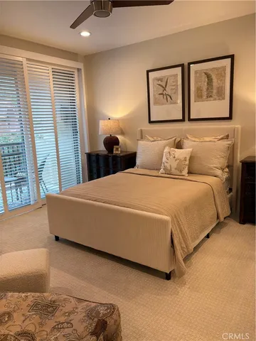 a bedroom with a large bed and a couch