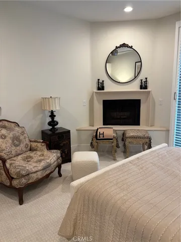 a bedroom with bed and a mirror