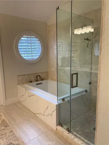 a bathroom with a bathtub and a shower