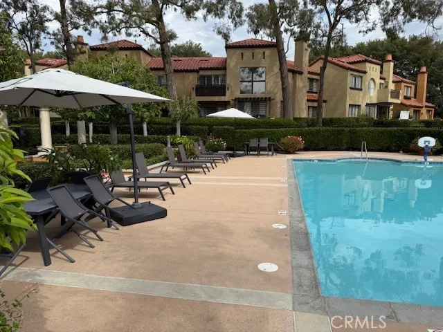 a view of a patio with table and chairs under an umbrella