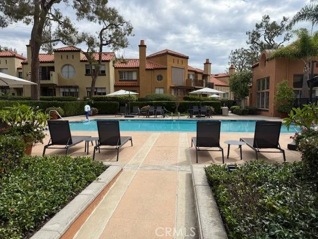 a view of a patio with table and chairs potted plants and a large tree