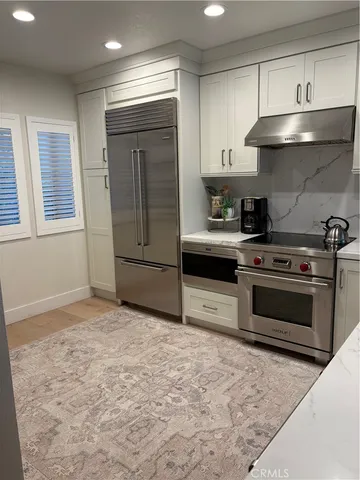 a kitchen with a stove and a refrigerator