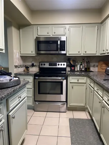 a kitchen with stainless steel appliances a refrigerator a stove a sink and dishwasher