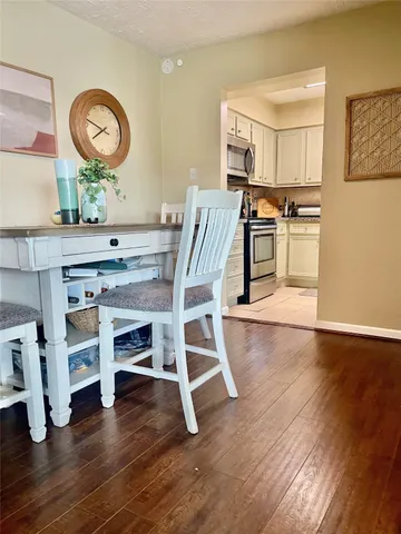 a kitchen with granite countertop a stove top oven microwave and cabinets