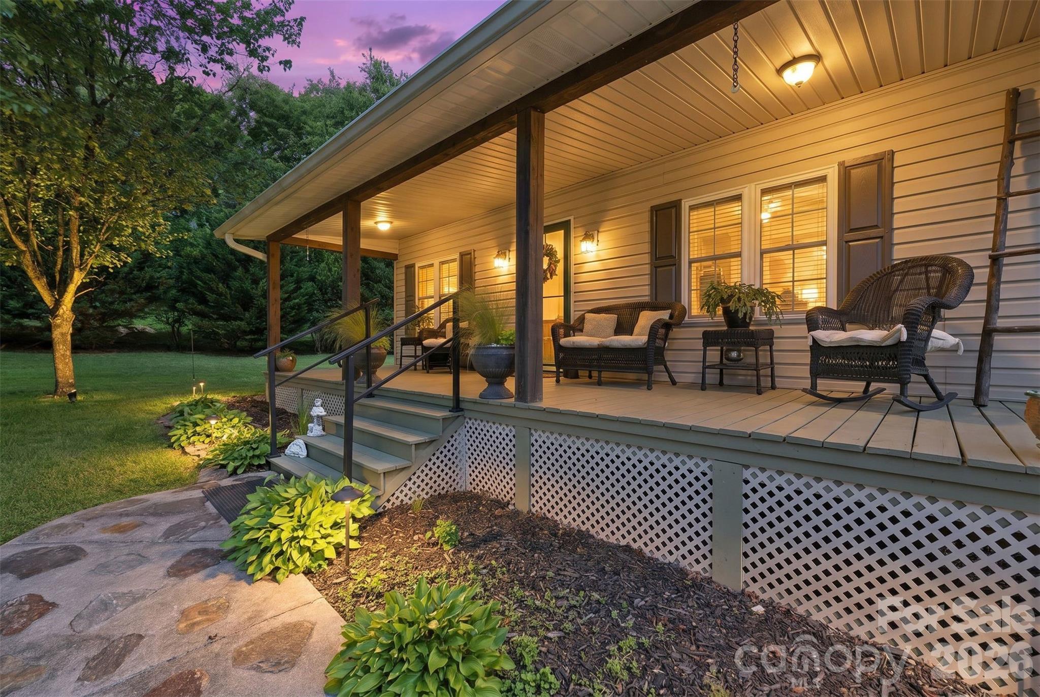 176-174 Oak Hollow Road Union Grove, NC 28689 - Photo 8 of 48 a view of a patio with dining table and chairs with a garden