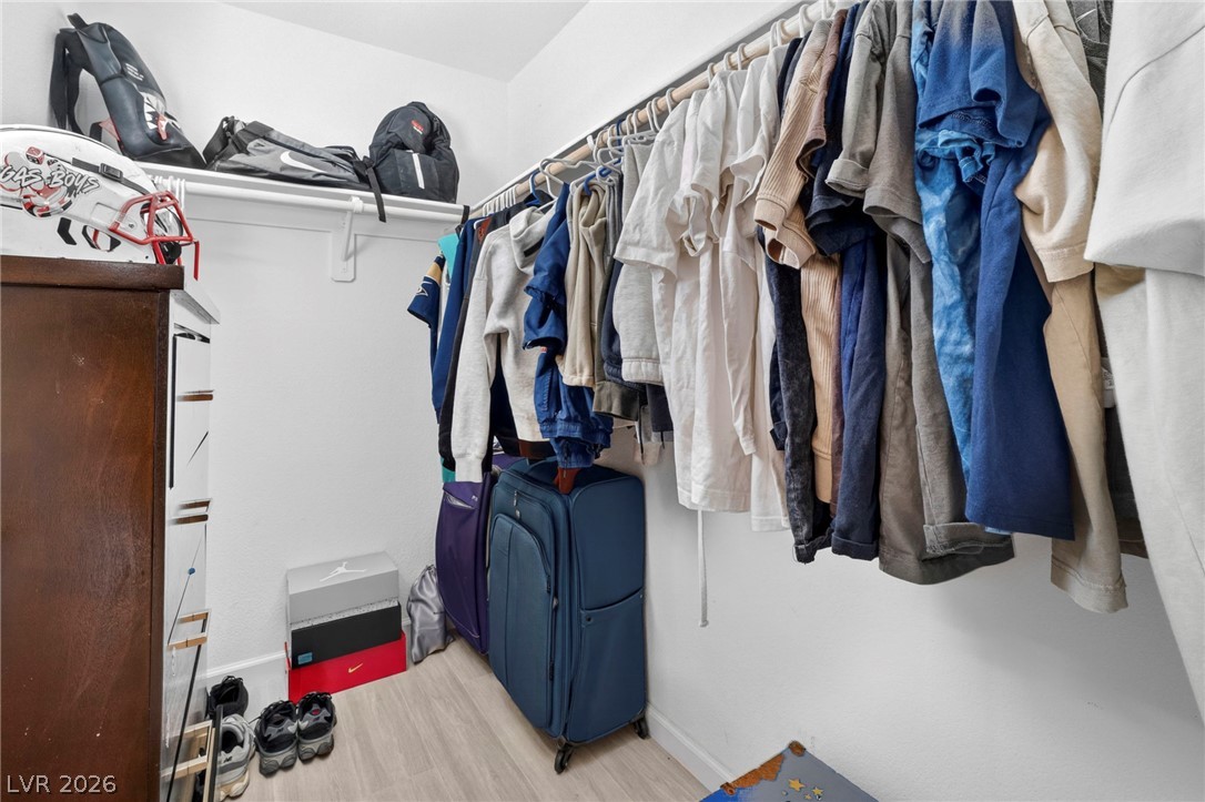 6281 Angora Peak Lane Las Vegas, NV 89115 - Photo 27 of 34 Ample hanging space and shelving offer practical storage solutions in this well-appointed closet.