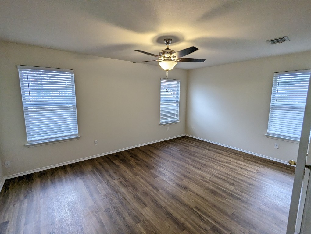 13512 Albania Way Austin, TX 78729 - Photo 11 of 24 a view of an empty room with wooden floor and a window
