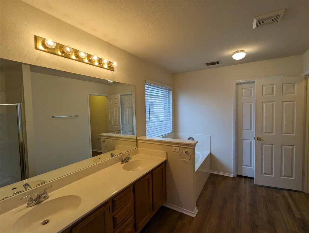 13512 Albania Way Austin, TX 78729 - Photo 12 of 24 a bathroom with a double vanity sink and a mirror