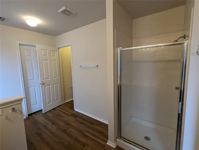 a view of a hallway with wooden floor