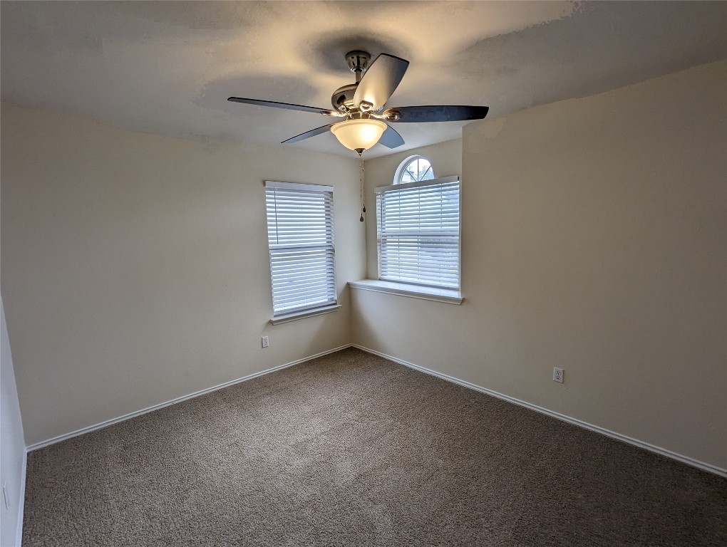13512 Albania Way Austin, TX 78729 - Photo 16 of 24 an empty room with a window and ceiling fan