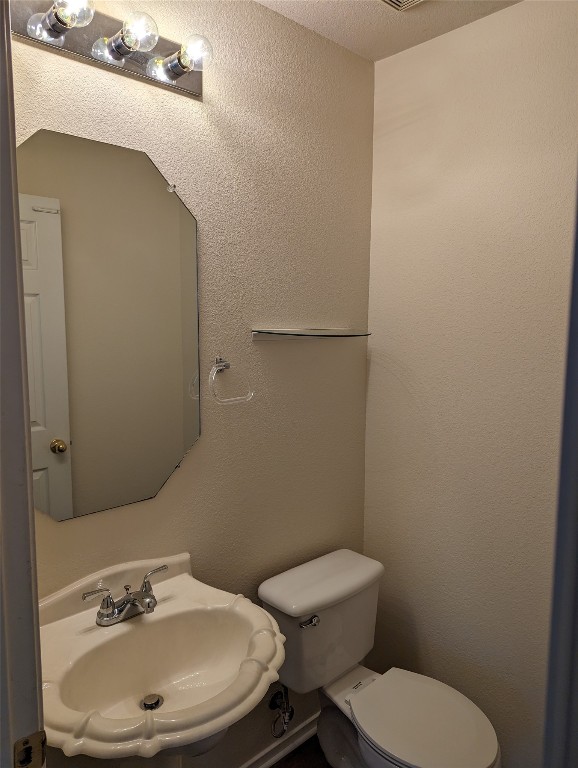 13512 Albania Way Austin, TX 78729 - Photo 19 of 24 a bathroom with a toilet and sink