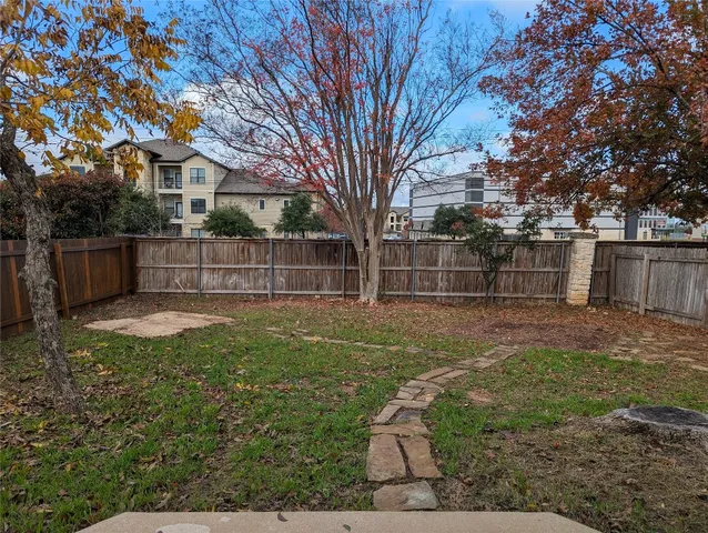 a view of a yard with a large tree