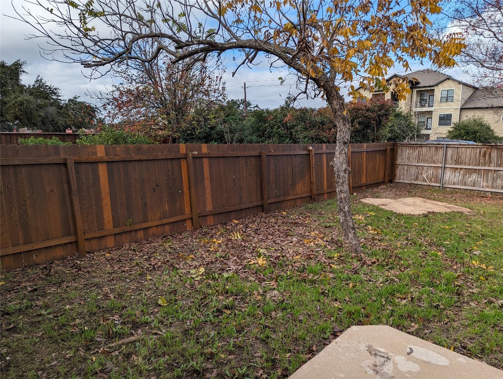 13512 Albania Way Austin, TX 78729 - Photo 22 of 24 a view of backyard with small cabin and wooden fence