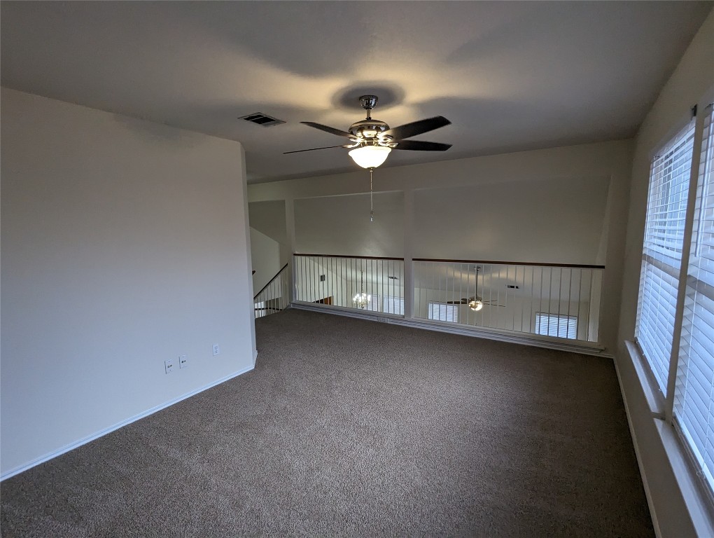 13512 Albania Way Austin, TX 78729 - Photo 5 of 24 an empty room with a ceiling fan and a window