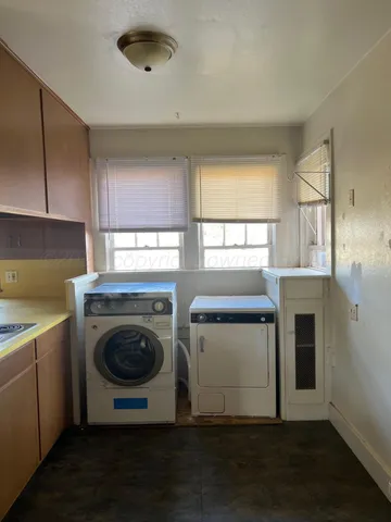 a utility room with sink dryer and washer
