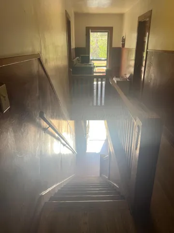 a view of staircase and living room with windows