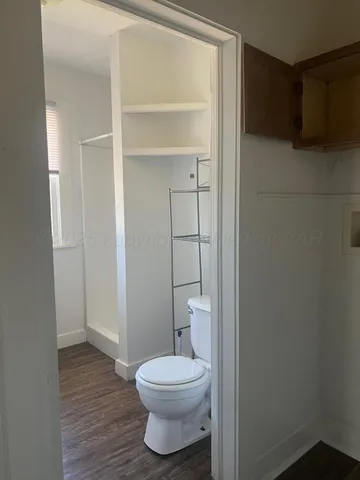 a bathroom with a toilet and a vanity