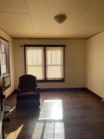 a living room with furniture window and wooden floor