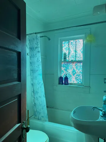 a bathroom with a sink mirror bathtub and toilet