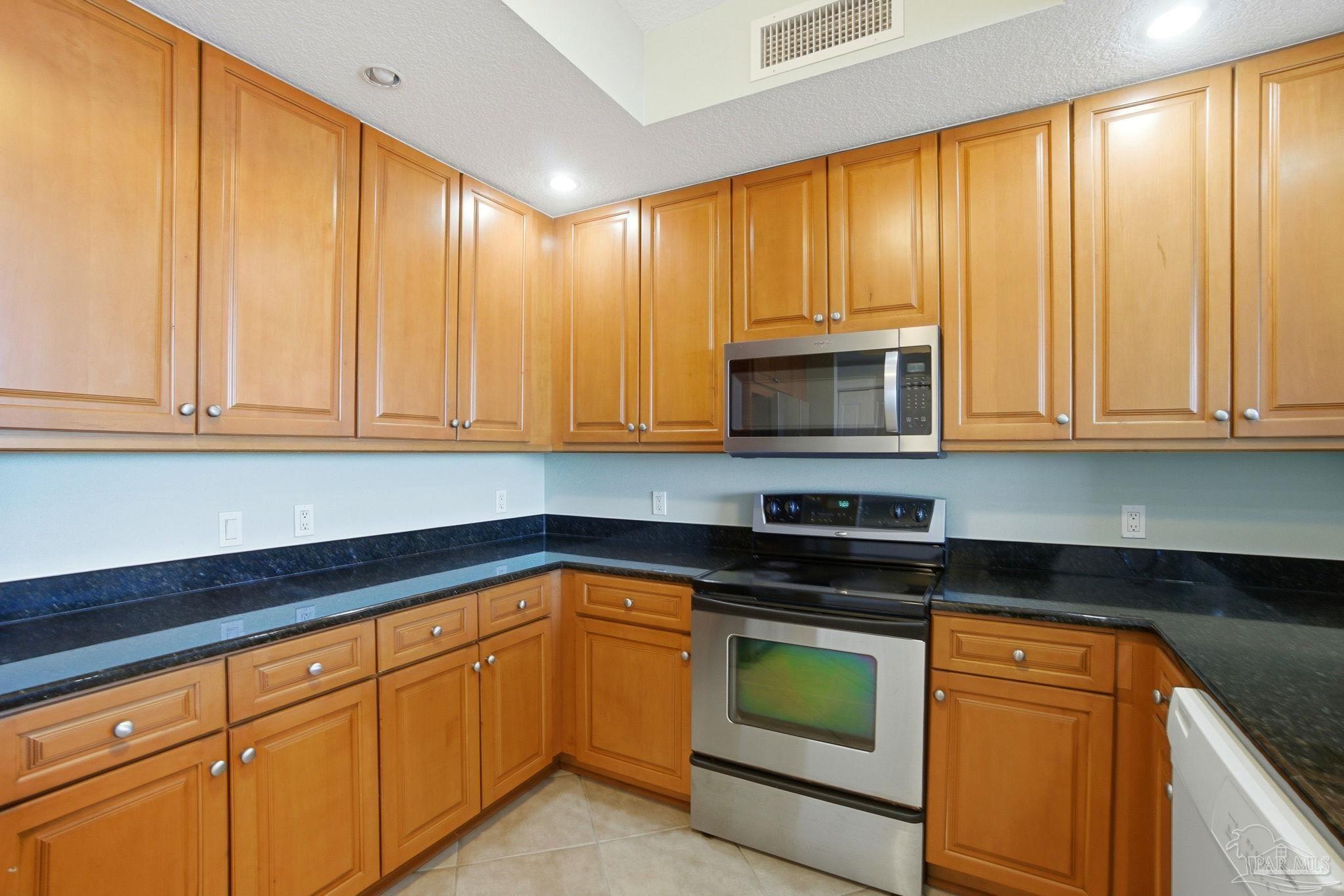 616 Lost Key Drive, Unit 603A Perdido Key, FL 32507 - Photo 3 of 53 a kitchen with granite countertop cabinets stainless steel appliances and a sink