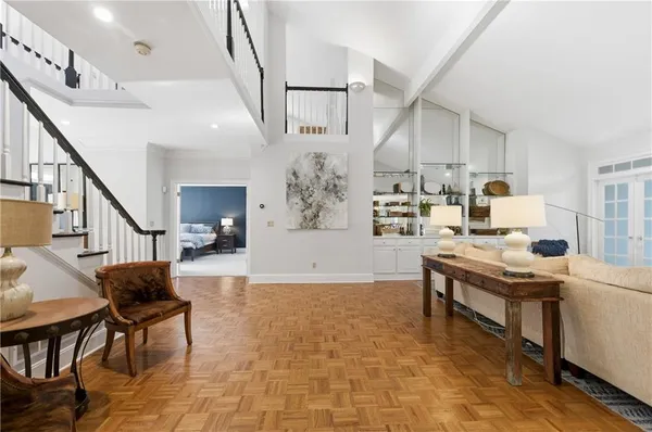 a living room with furniture and kitchen view
